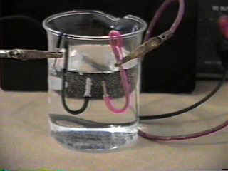 Electrolysis with electrolyte added to water.